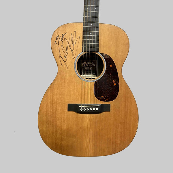 Martin 00X1AE Acoustic-Electric Guitar with a Richie Kotzen autograph on the wooden body and a dark tortoiseshell pickguard.