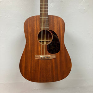 Martin D-15M Natural acoustic guitar hanging on a wall, showcasing its solid mahogany construction and dreadnought shape, available at Guitars on Main.