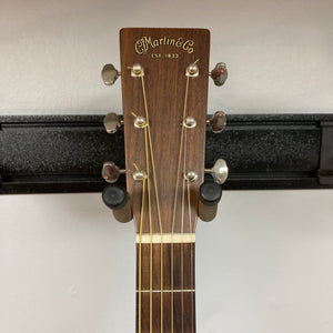 Martin D-15M Natural w/Case Used - Acoustic guitar on a stand, highlighting its solid mahogany construction and timeless dreadnought shape.