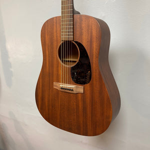 Martin D-15M Natural acoustic guitar displayed on a wall, showcasing its solid mahogany construction and dreadnought shape.