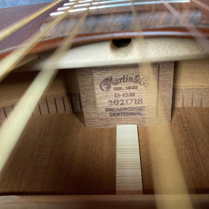 Martin D-15M Natural acoustic guitar close-up, highlighting mahogany construction, strings, and bridge.