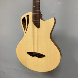 Murray Kuun Coupe Natural Acoustic Guitar hanging on a wall, showcasing its elegant craftsmanship and design, ideal for enthusiasts at Guitars on Main.