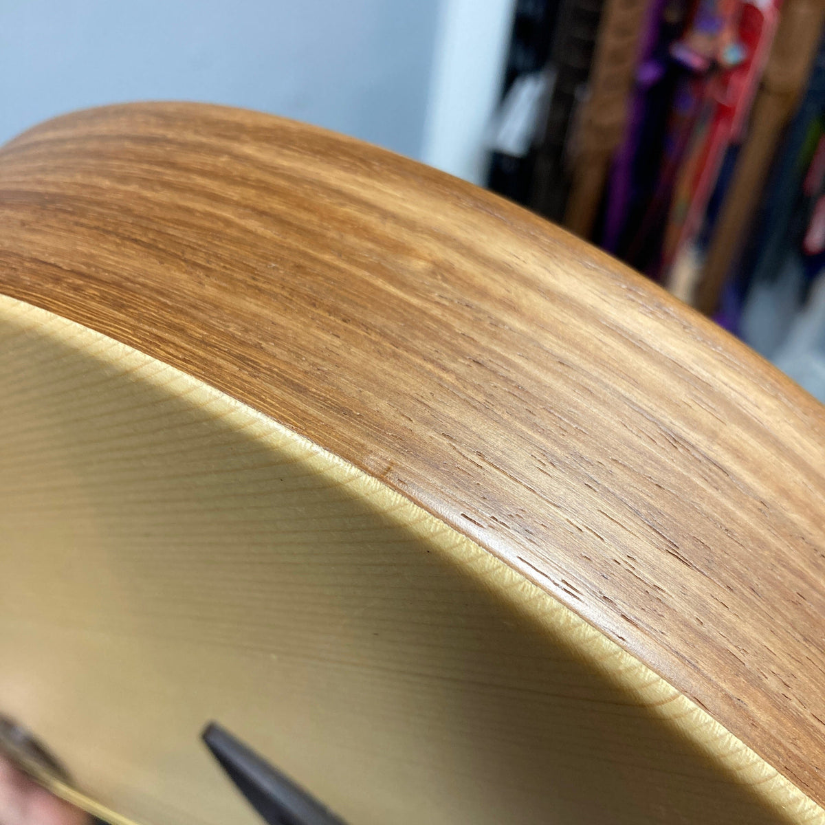 Close-up of the Murray Kuun Coupe Natural Acoustic Guitar&#39;s wood grain surface, highlighting its fine craftsmanship and design.