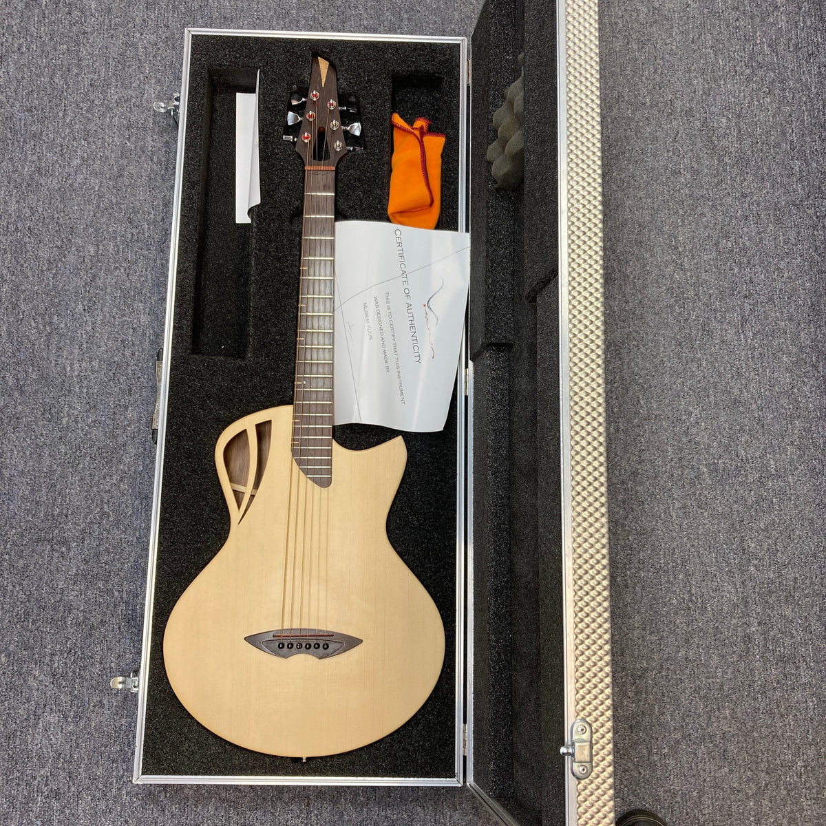 Murray Kuun Coupe Natural Acoustic Guitar in a protective case, showcasing elegant design and craftsmanship, perfect for music enthusiasts and collectors.