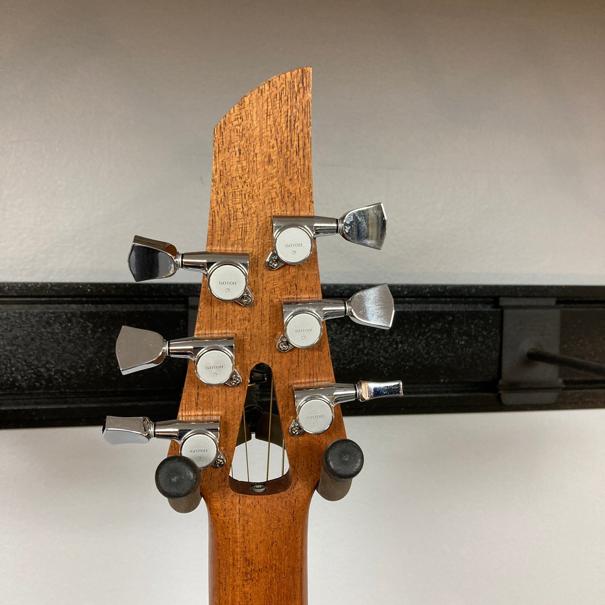 Murray Kuun Coupe Natural Acoustic Guitar close-up, highlighting intricate wooden design and craftsmanship, showcasing the guitar&#39;s unique structural features.