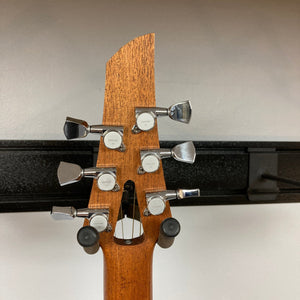 Murray Kuun Coupe Natural Acoustic Guitar close-up, highlighting intricate wooden design and craftsmanship, showcasing the guitar's unique structural features.