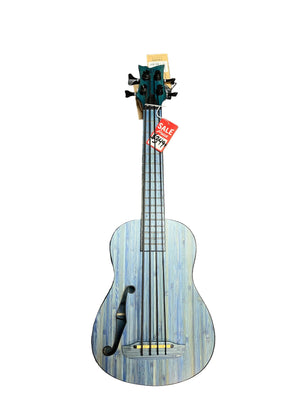 An Ortega RUSWB-UB Uke Bass Stonewashed with a vintage finish and f-hole design rests on a gray carpet; this Ortega instrument features a red sale tag on its headstock.