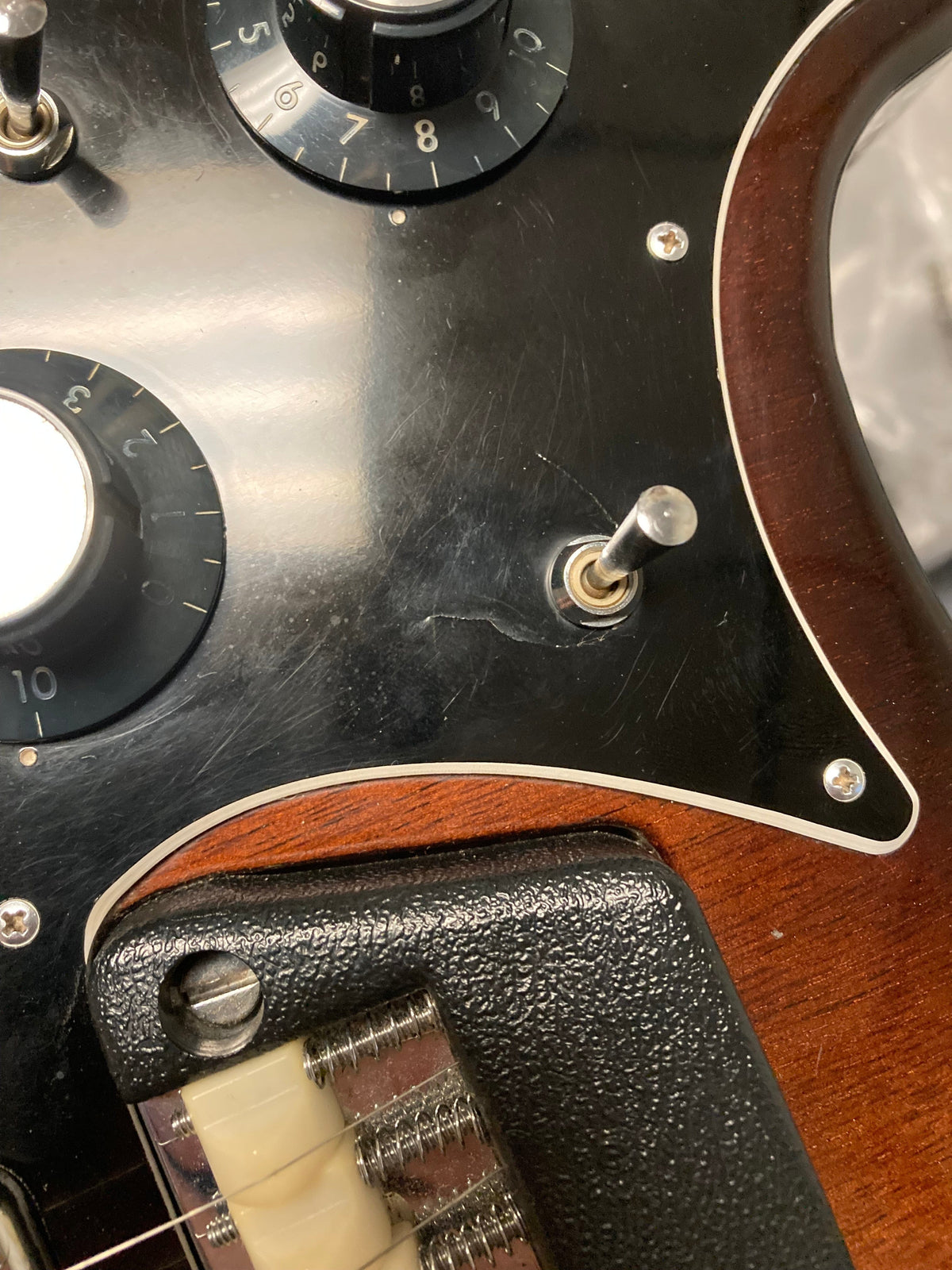 Ovation Deacon 1973-1975 Sunburst Electric Guitar, close-up of body, showing vintage sunburst finish and minor wear around the toggle switch.