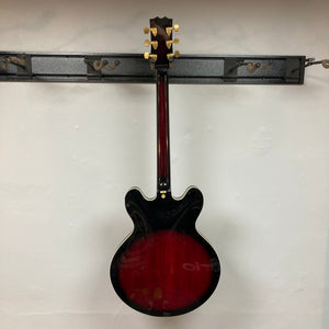 Palmer Semi-hollow 1970-80s ES-335 guitar on wall, showcasing vintage hardware, dual humbucker pickups, and semi-hollow body design.