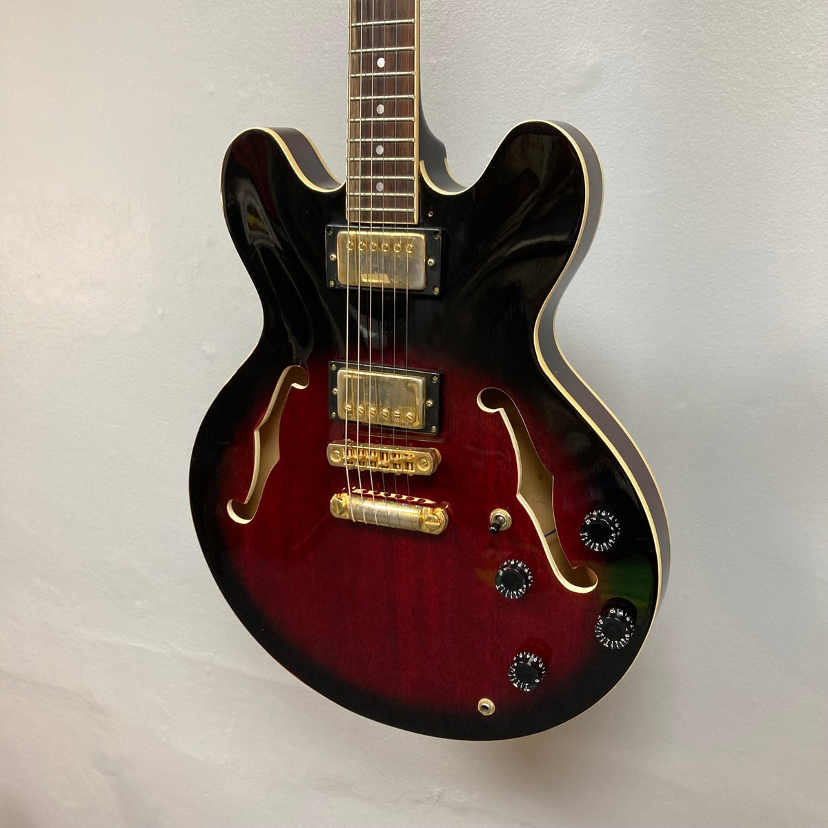 Palmer Semi-hollow 1970-80s ES-335 guitar, set neck, dual humbuckers, and vintage hardware, displayed on a wall.