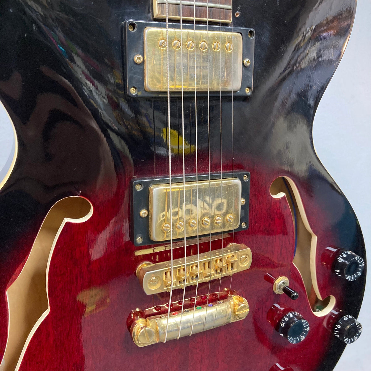 Close-up of a Palmer Semi-hollow 1970s guitar, showcasing its f-holes and dual humbucker pickups.