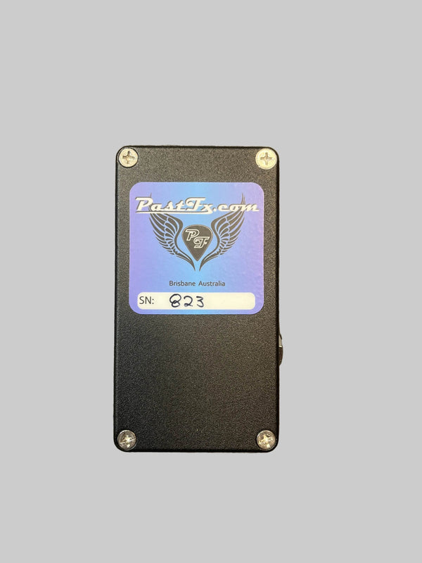 A preowned PastFx TD-Y Overdrive Pedal by PastFx is displayed on a textured gray surface. This black boutique unit features four control knobs labeled LO, HI, LEVEL, and GAIN, along with a footswitch. Renowned for its studio-quality tone and touch-sensitive overdrive, it’s an ideal choice for discerning guitarists.
