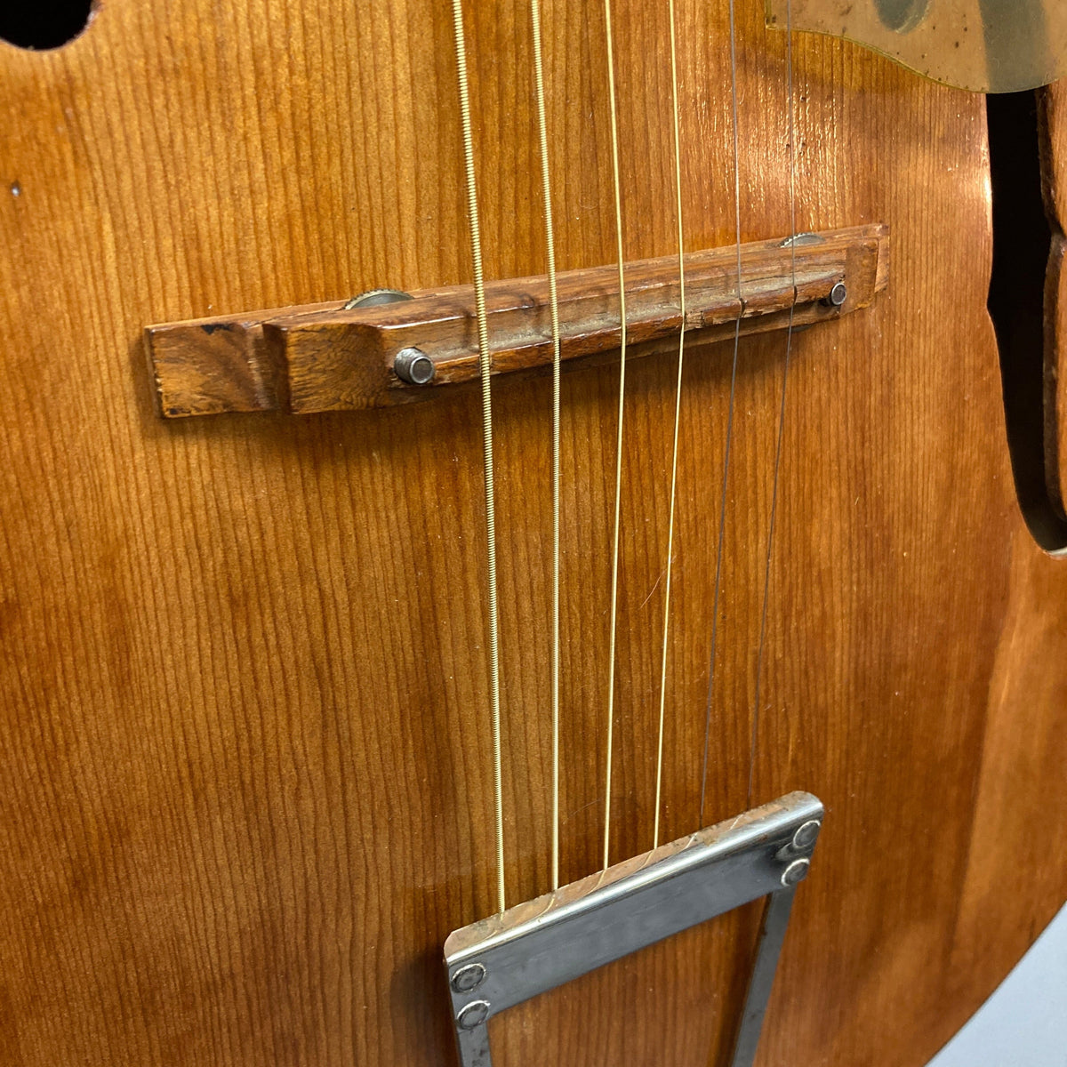 Close-up of Playtime by Harmony Vintage Archtop Guitar from the 1940s, highlighting its strings and wooden body, ideal for musicians and collectors.