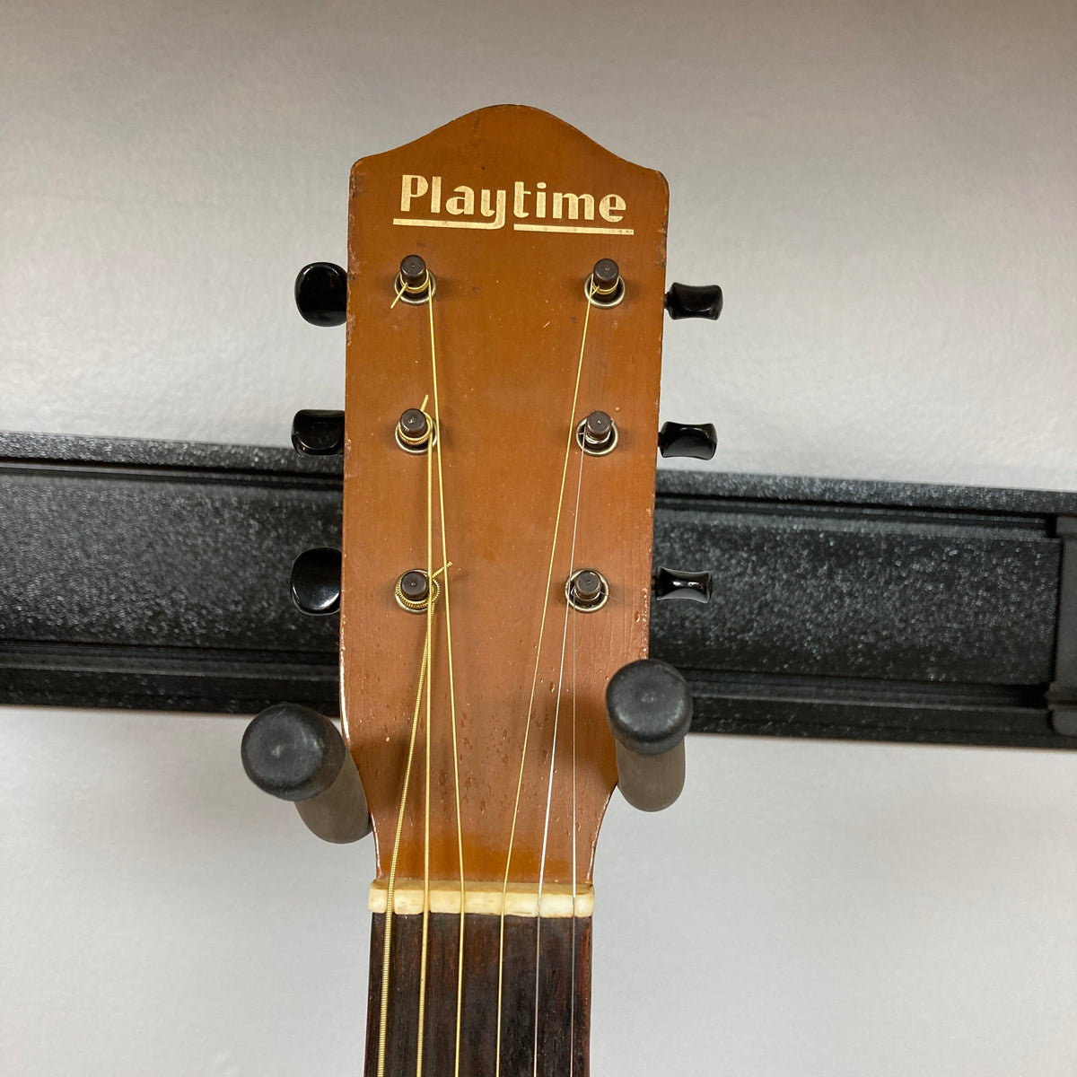 Playtime by Harmony Vintage Archtop Guitar from the 1940s on a stand, showcasing classic design and strings, ideal for musicians and collectors.