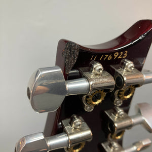 Close-up of a PRS Custom 24 Angry Larry 2011 electric guitar headstock displaying the tuning pegs, serial number “11 76923,” and a noticeable chip on the wood near the top edge.