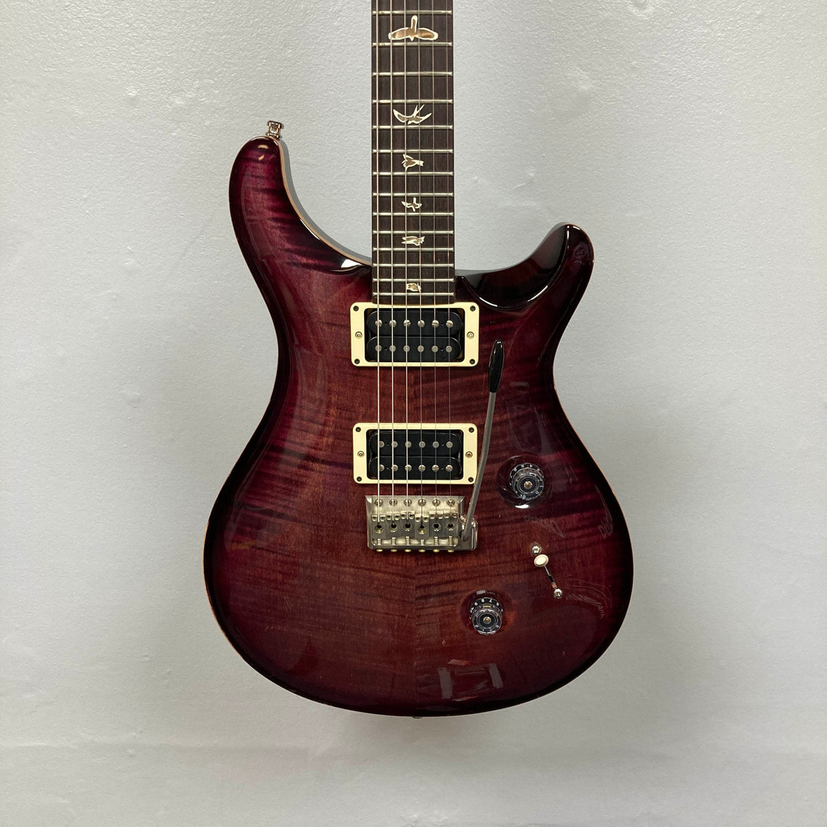 The PRS Custom 24 Angry Larry 2011 w/Case Used features a striking dark red, glossy finish, two powerful humbucker pickups, three control knobs, and signature bird inlays on the fretboard—all set against a plain light background, showcasing the classic PRS design.