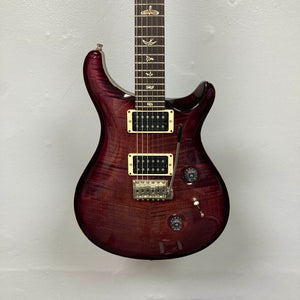 The PRS Custom 24 Angry Larry 2011 w/Case Used features a striking dark red, glossy finish, two powerful humbucker pickups, three control knobs, and signature bird inlays on the fretboard—all set against a plain light background, showcasing the classic PRS design.