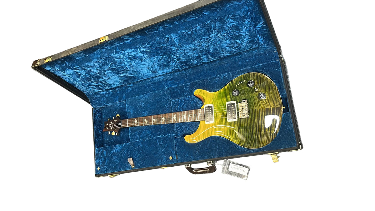 A PRS P22 Artisan Piezo Green Fade 2013 electric guitar with a Brazilian rosewood fretboard is displayed in an open blue velvet-lined hard case.