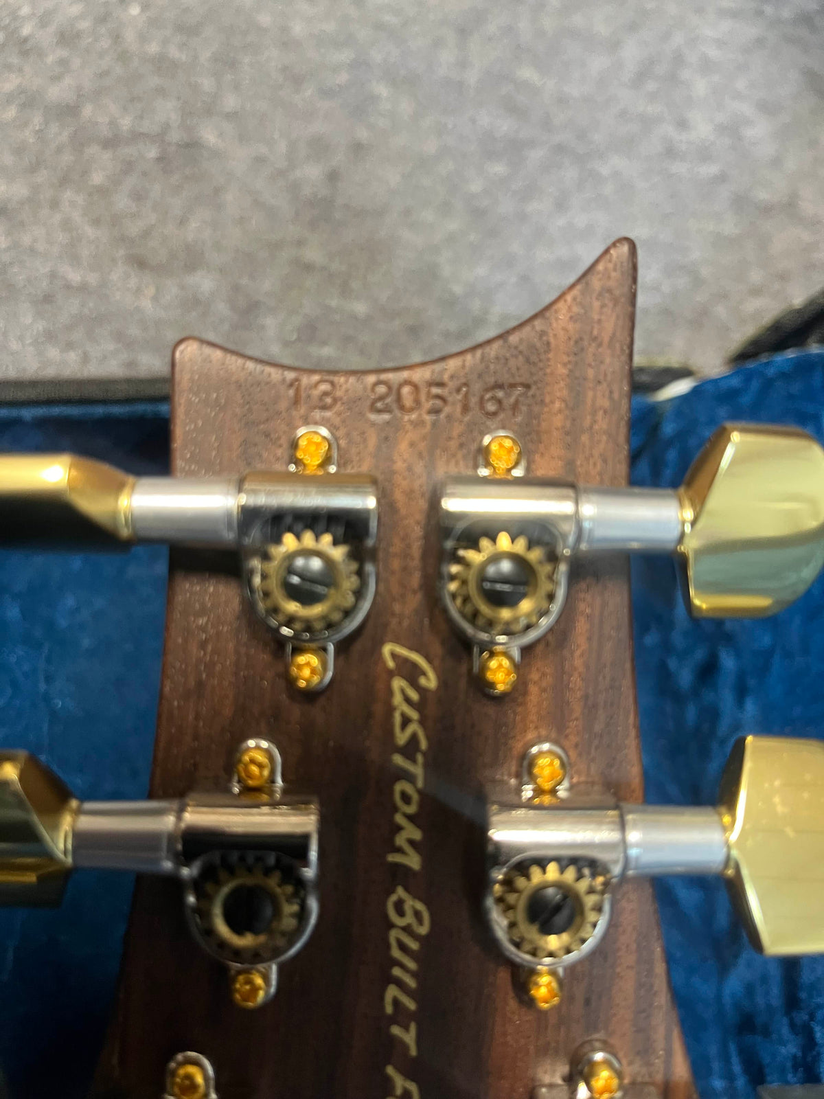 Close-up of a PRS P22 Artisan Piezo Green Fade 2013 Brazilian Rosewood headstock with tuning pegs, serial number "13 205167," and "Custom Built" in gold script.