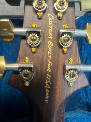 Close-up of the back of a PRS P22 Artisan Piezo Green Fade 2013 Brazilian Rosewood headstock with gold tuners and "CUSTOM BUILT FOR U.S.A. ONLY" inscription, showcasing PRS quality and renowned piezo versatility.