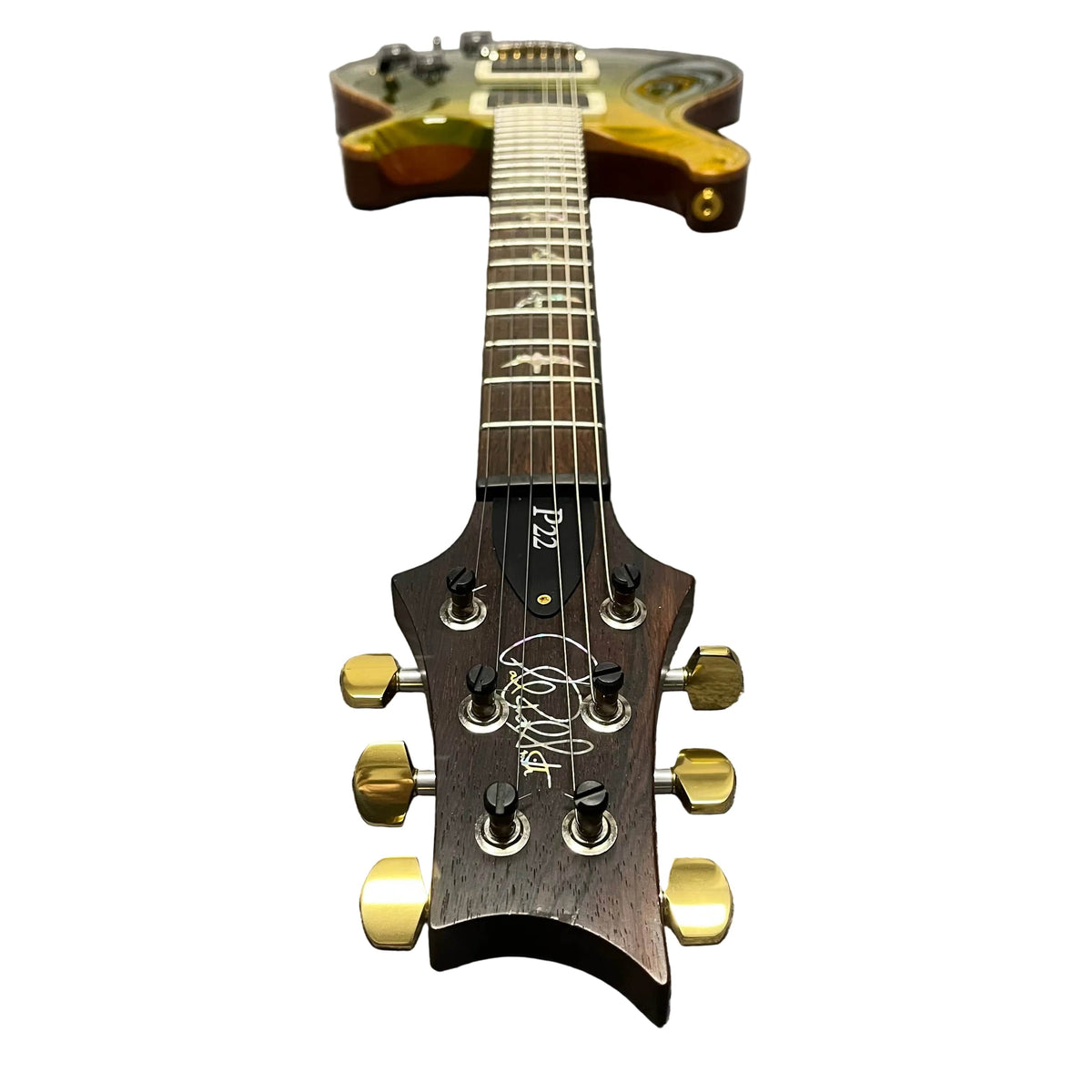 PRS P22 Artisan Piezo Green Fade 2013 Brazilian Rosewood electric guitar by PRS, photographed from the headstock, showcasing gold tuning pegs, bird inlays on the fretboard, and its glossy body in the background.