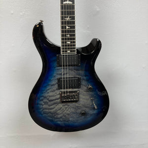 PRS SE Mark Holcomb - Holcomb Blue Burst w/Gigbag Used Consign by PRS, featuring a quilted maple top, Seymour Duncan humbuckers, and bird inlays, shown against a plain light wall.