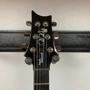 Close-up of the headstock of a PRS SE Mark Holcomb - Holcomb Blue Burst w/Gigbag Used Consign, mounted on a hanger against a white wall.