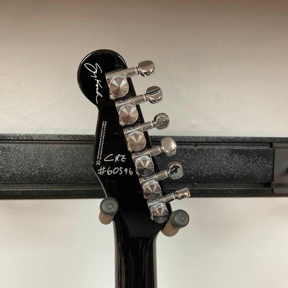 Close-up of the back of a Reverend Greg Koch Signature Gristle 90 headstock in 3-Tone Burst, showing six tuning pegs, a signature, and the markings "CR2 #60596" in white.