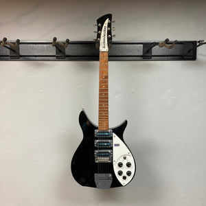 Rickenbacker 325C64 Jetglo 2007 on a hook, showcasing its iconic design and brown neck.