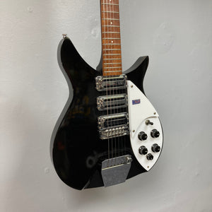 Rickenbacker 325C64 Jetglo 2007 electric guitar, black and white, displayed on a wall.