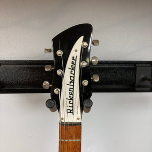 Rickenbacker 325C64 Jetglo guitar, close-up showing strings and body, hanging on a wall.