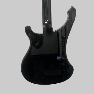 Mounted on a white wall, the sleek black Rickenbacker 4003 Bass Guitar – 2020 Jetglo w/Case reflects a person and objects in the room. Its lustrous finish and signature curves capture the timeless allure of this iconic Rickenbacker bass.