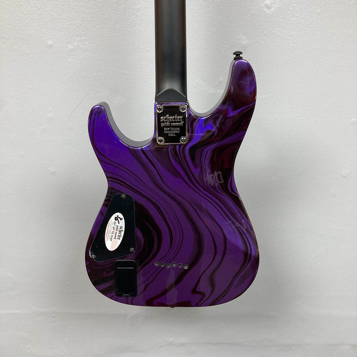 Back view of a Schecter C-1 Hydro-Dip Purple Obsidian electric guitar body featuring a purple and black marbled finish and a black neck.