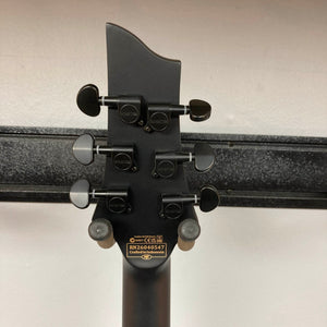 Back of a Schecter C-1 Hydro-Dip Purple Obsidian headstock featuring six black tuning pegs and a plate displaying serial number RN26045047 and “Crafted in Indonesia.”