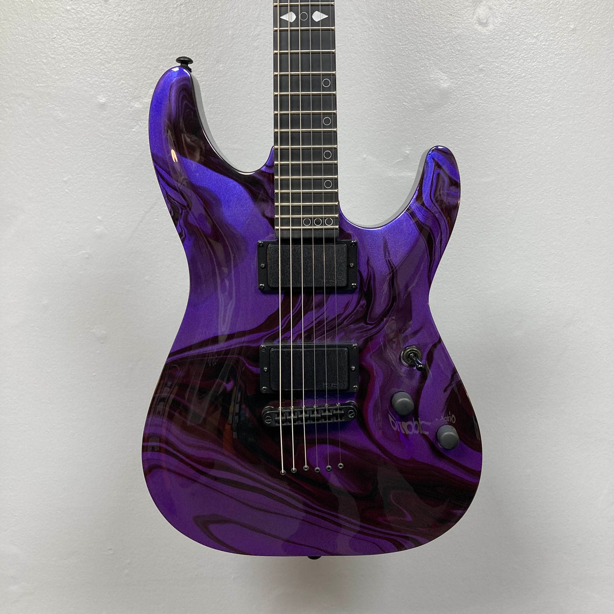 Schecter C-1 Hydro-Dip Purple Obsidian electric guitar with a purple and black marbled finish, two active pickups, and a fretboard with circle inlays.
