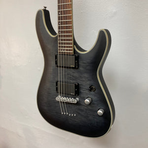 Schecter C-1 Platinum Translucent Black Used: black electric guitar with a maple neck, rosewood fretboard, and EMG Active 81/85 pickups on a wall.