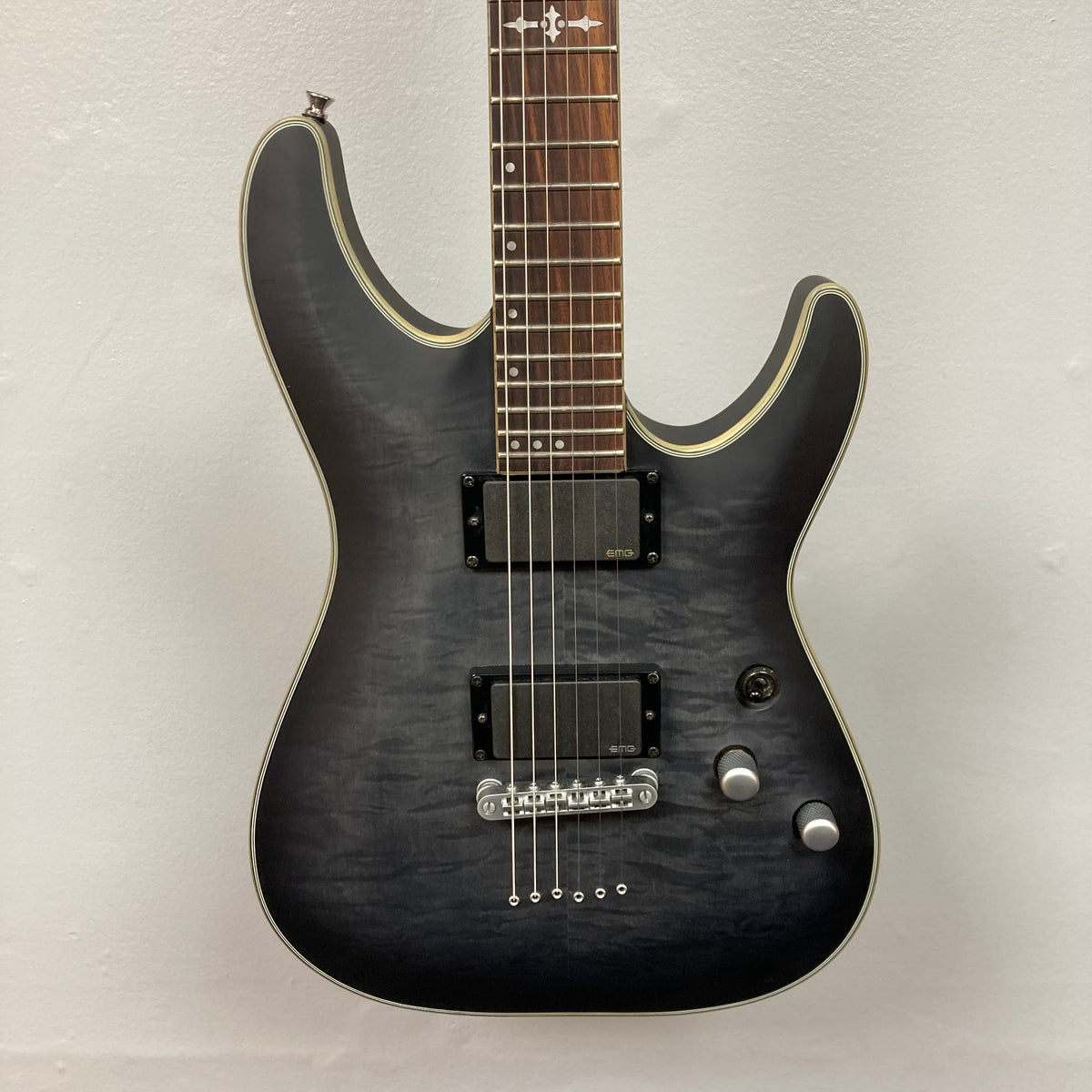 Schecter C-1 Platinum Translucent Black Used electric guitar with a maple-topped mahogany body, double-cutaway design, and EMG Active 81/85 pickups.