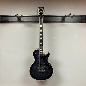 A Schecter Solo-II Custom Trans Black Burst w/Case Used by Schecter hangs on a wall-mounted rack against a plain white background.