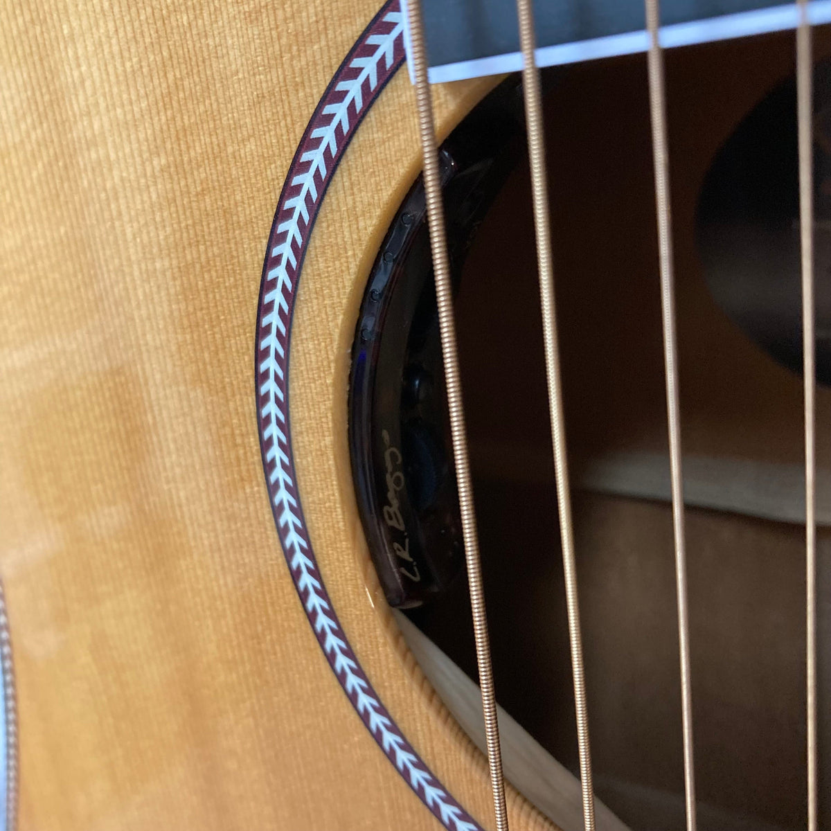 Close-up of the Seagull Artist Mosaic CW HG EQ guitar, showcasing its high-gloss mahogany body, solid spruce top, and discrete LR Baggs Anthem system.