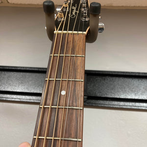 Close-up of a Seagull S6 QI Slim Acoustic Guitar neck with six strings and signature logo on the headstock, displayed on a wall hanger. Includes hard case—ideal for anyone wanting a quality, travel-friendly acoustic guitar.