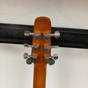 Back of a Seagull S6 QI Slim Acoustic Guitar w/Hard Case - USED/consign headstock, showing six tuning pegs and part of the neck, with a black hanger and white wall—travel-friendly solid spruce top acoustic by Seagull.