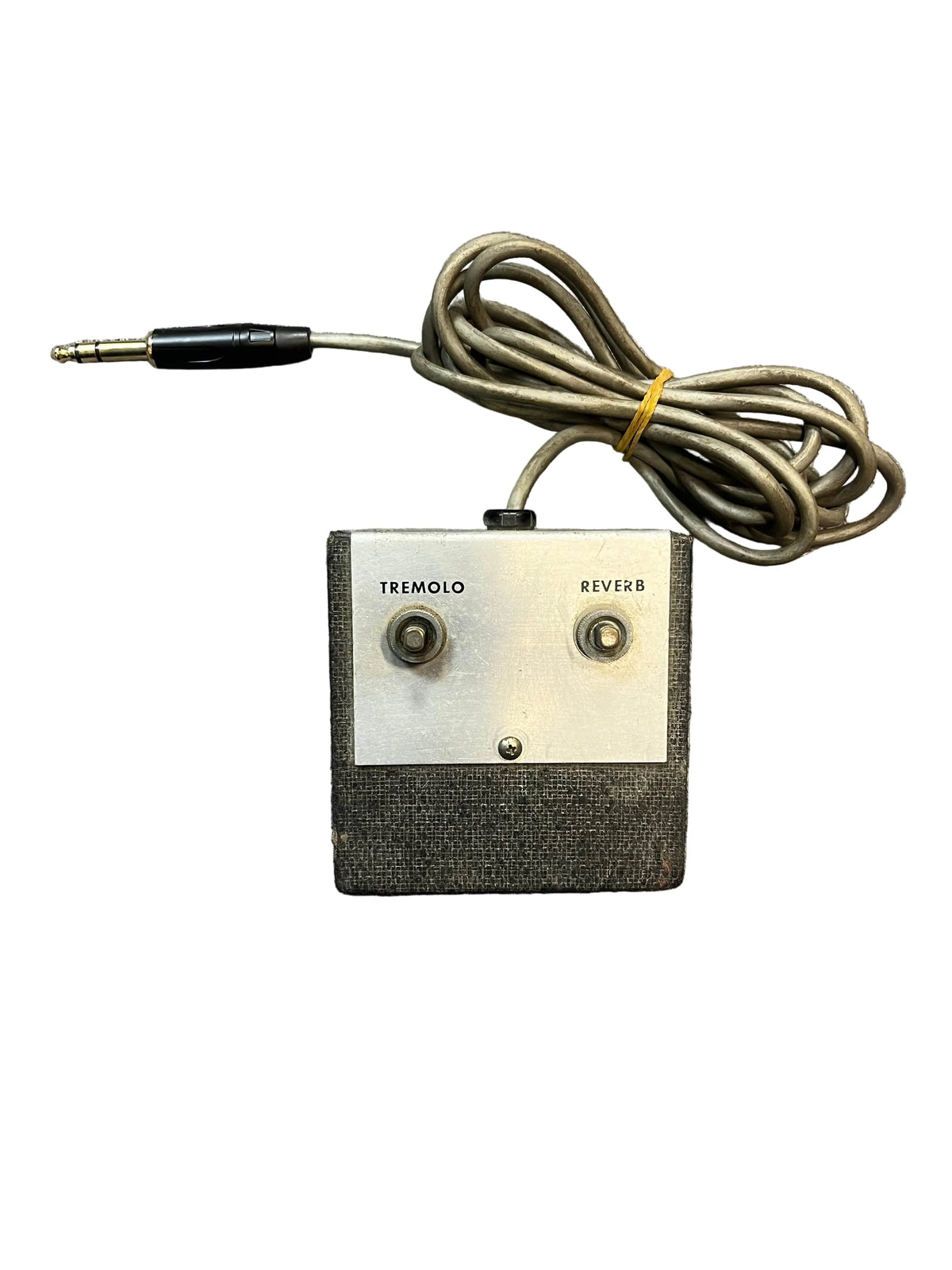 A vintage Silvertone 1484 Tremolo Reverb Footswitch 1960s in gray with tremolo and reverb buttons, attached cable, and a 1/4-inch jack plug.