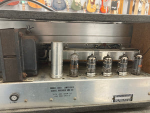 Close-up of a vintage Silvertone Model 1484 Twin Twelve Guitar Amp from the 1960s with visible tubes and metal components.