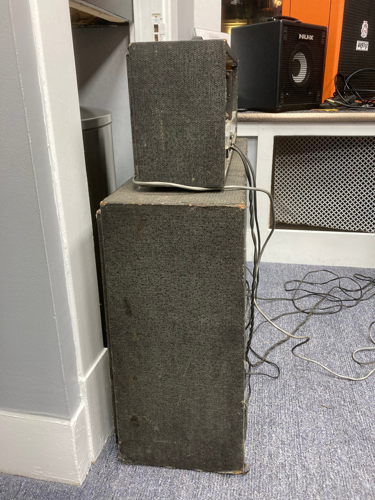 Silvertone Model 1484 Twin Twelve Guitar Amp 60&#39;s with original 2x12 cabinet, shown among other speakers and tangled wires on a floor.