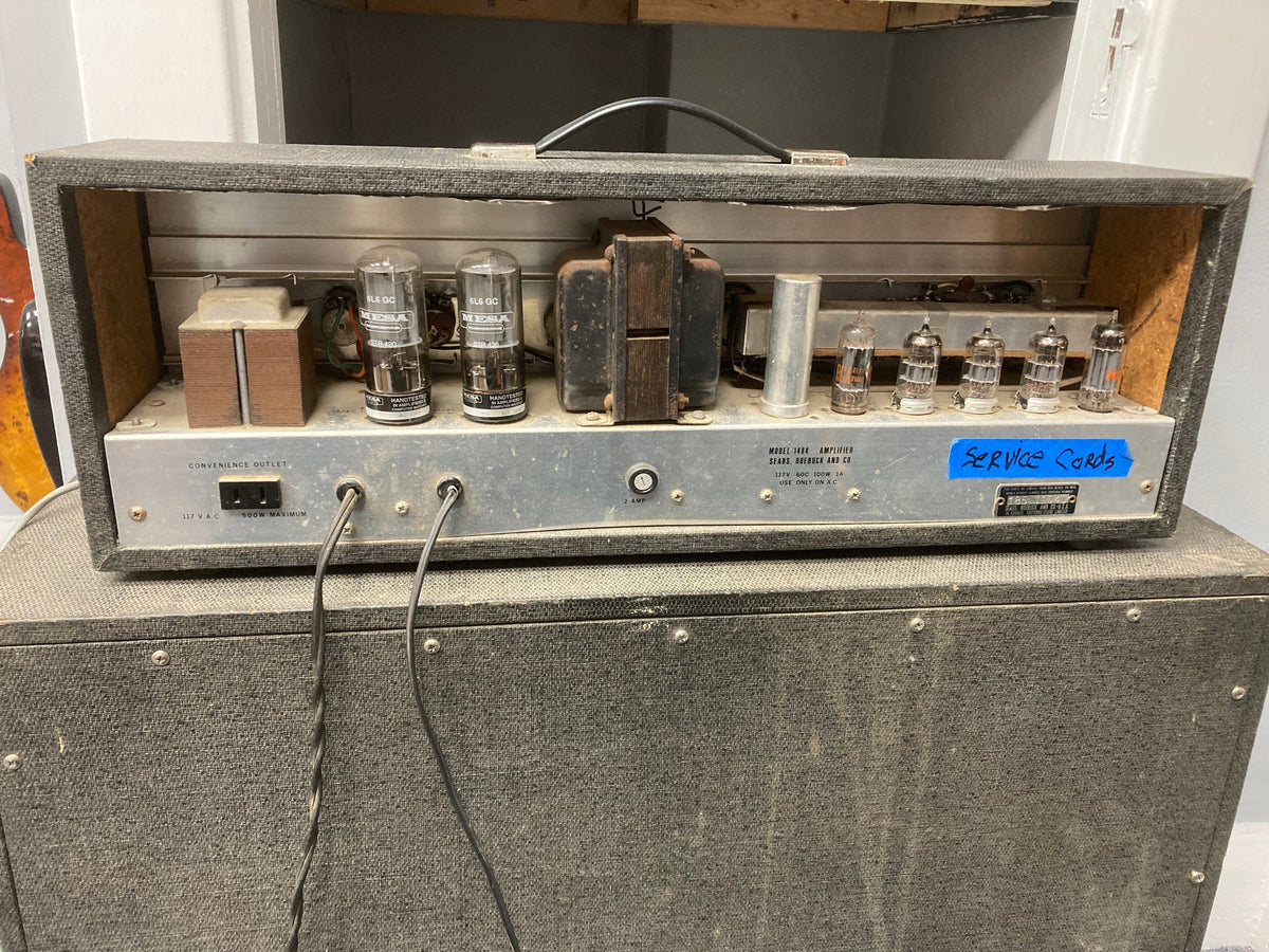 Silvertone Model 1484 Twin Twelve Guitar Amp from the 60s with several tubes visible, showcasing its vintage design and original 2x12 cabinet.