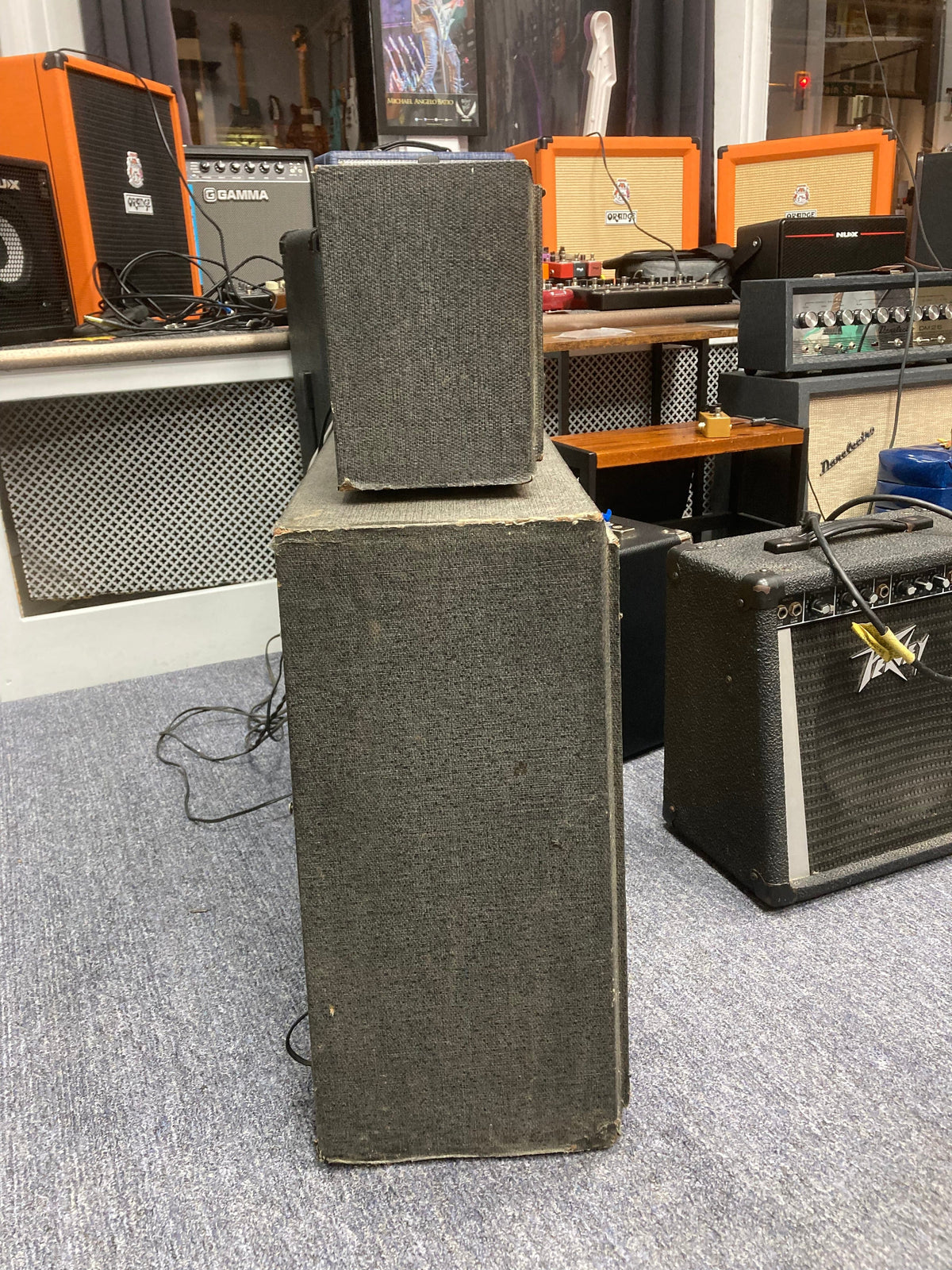 Silvertone Model 1484 Twin Twelve Guitar Amp with original 2x12 cabinet on floor, showcasing vintage design and attached yellow cable.