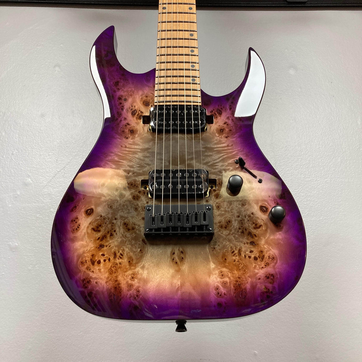 Spira S-457 TPP Trans Purple Burst Electric Guitar, featuring a natural burl-wood top, two humbuckers, fixed bridge, and control knobs for versatile playability.