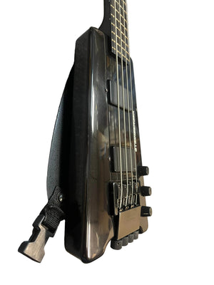 Close-up of a black 1984 Steinberger XL-2 Bass USA, a headless four-string bass guitar by Steinberger, highlighting the bridge, knobs, and strap detail against a white background.