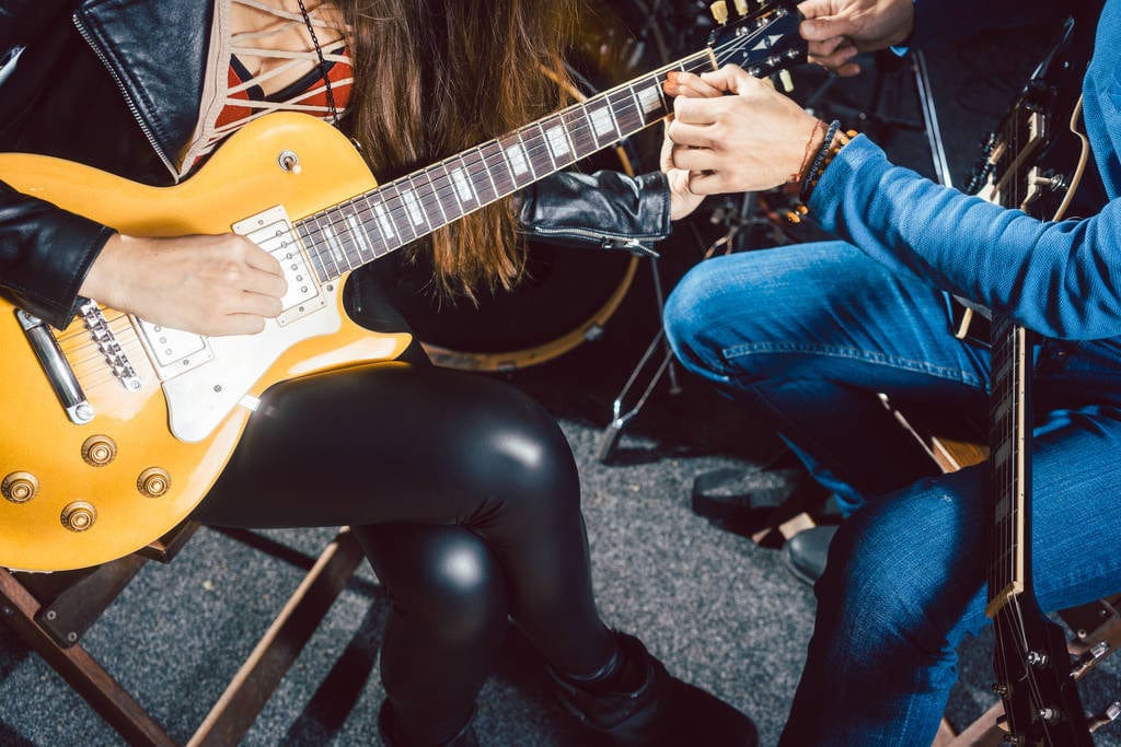 a guitar lesson in progress