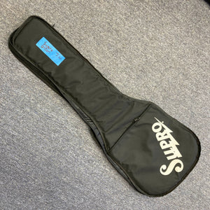 A black Supro soft-sided gig bag rests on a gray carpet, featuring a blue label marked "2352 me case" near the top. Ideal for storing your Supro 1296 Silverwood British Racing Green w/Gigbag Used guitar with Gold Foil pickups.